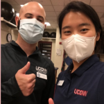 man and woman from UConn Athletic Training wearing masks and giving thumbs up